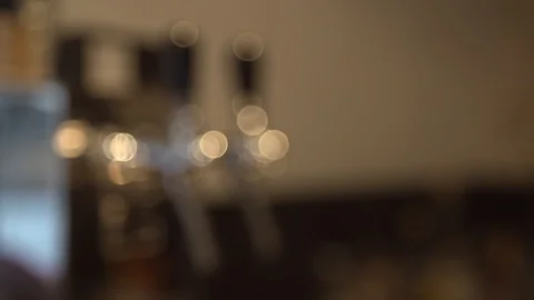 A pull focus shot on a beer tap in a pub Stock Footage 87857120