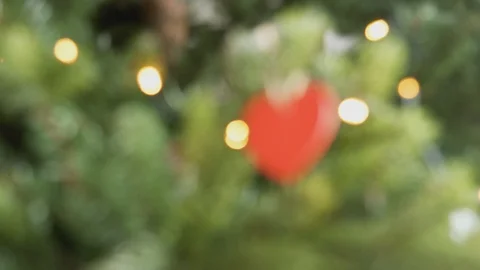 Pull Focus Shot Of Heart Shaped Decoration Hanging On Christmas Tree Stock Footage