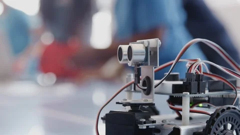 Pull Focus Shot Of Robot Vehicle In After School Programming Club Stock Footage 111933647