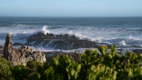 Pull focus, slomo footage of Atlantic Ocean waves breaking onto rocks. Stock Footage 306839624