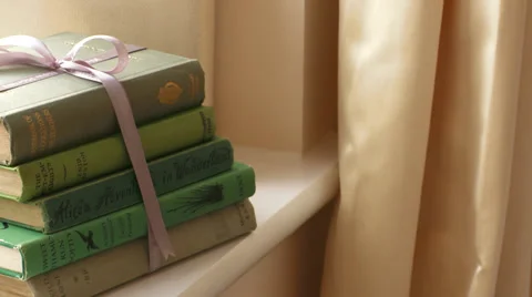 Pull focus on stack of Books in nice home Stock Footage 35600098