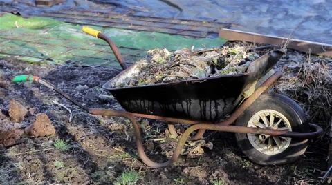 Pull Focus Wheel Barrow Rural Allotment Gardening Tools Village - Morning Light Video stock 48982509