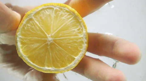 Pull half lemon from water Stock Footage 62986634