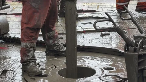 Pull of of hole drill string with oil based mud on the rig floor. Stock Footage 323474284