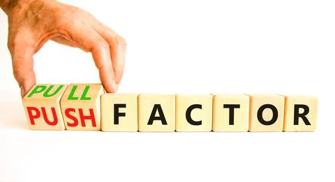 Pull or push factor symbol. Concept word Pull factor and Push factor on woode Stock Photos