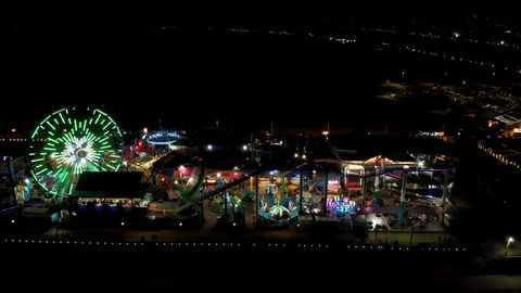 Pull Out Aerial Shot of Santa Monica Pier Lights and Beach At Night Stock Footage 127805318