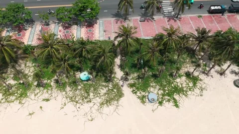 Pull out drone shot of Carl walking on a beach in Da Nang, Vietnam 스톡 동영상 313251065
