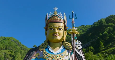Pull out drone shot of Pharping Nepal showing the grand blue Guru Rinpoche Stock Footage 337140070