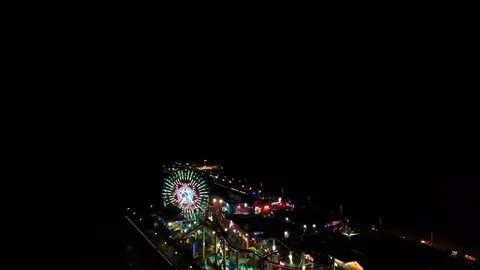 Pull Out Drone Shot of Santa Monica Pier Lights and Beach At Night Stock Footage 127805299
