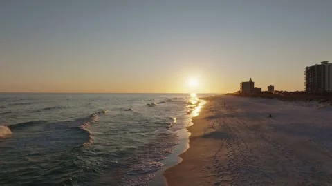 Pull out elevation revealing aerial drone shot of sunset on Pensacola beach at Stock Footage 302192206