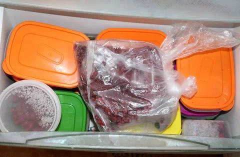 Pull-out freezer drawer in home refrigerator with plastic bags and trays wi.. Stock Photos