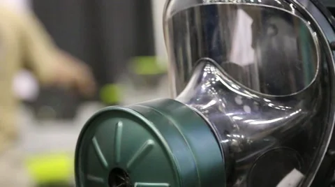 Pull Out from Gas Mask to Display Table at Prepper Trade Show Stock Footage 64906888