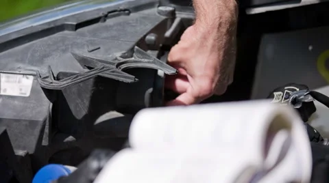 Pull out headlights bulb and put in new close up Stock Footage 52960314