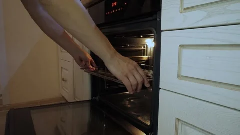 Pull out a rack from the open space of an oven Stock Footage 340016039