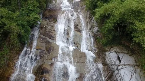 Pull out shot from drone revealing a beautiful view of a waterfall Stock Footage 106985887