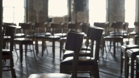 Pull out shot of lined up wooden chairs Stock Footage 139976071