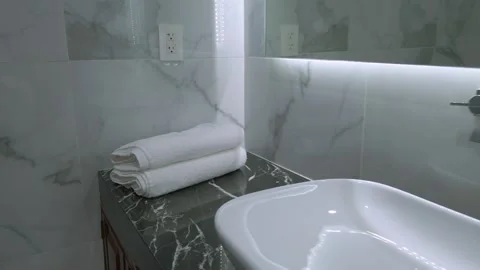 Pull out shot of modern luxury bathroom with vessel sink, marble walls Stock Footage 339832040