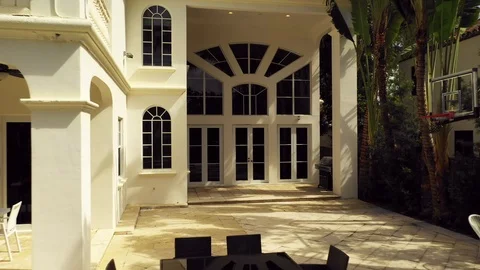 Pull out shot revealing a mansion with swimming pool Miami 4k Stock Footage 125057962