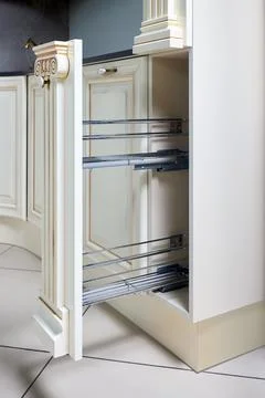 Pull out spice rack cabinet filler pantry. Interior of modern kitchen in clas Stock Photos