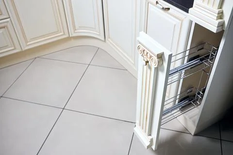 Pull out spice rack cabinet filler pantry. Interior of modern kitchen in clas Stock Photos