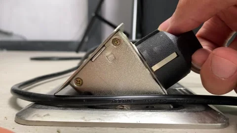 Pull plug from floor box outlet socket power supply appliance close up view Видео 249815412
