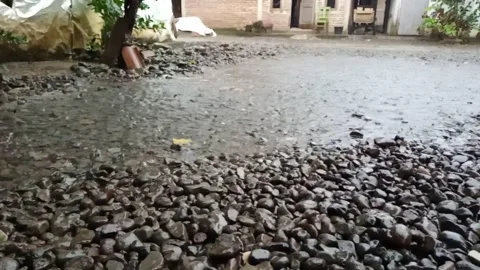 PULL OF RAIN WATER IN FRONT OF THE HOUSE Stock Footage 230964562