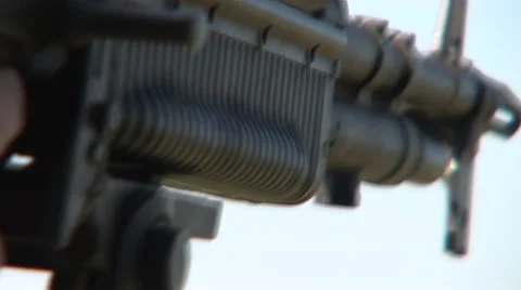Pull reveals cradling machine gun on a flying helicopter gunship Video stock 45470758