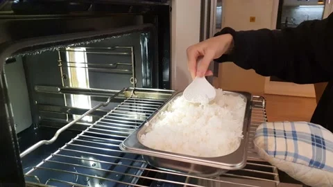 Pull rice out of the steam oven Stock Footage 159141529