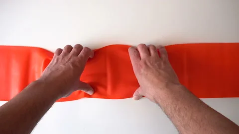 Pull the rubber orange tape hands 4K Stock Footage 89631883