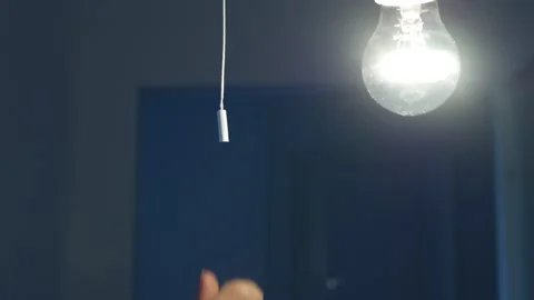 Pull Switch On Off, Turning the Light On a Led Bulb, Turn On the Light in a Dark Stock Footage 236631453