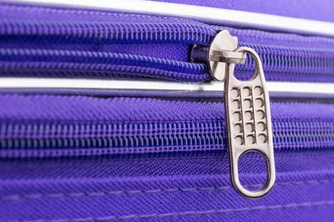 Pull Tab and Chain of a Zipper on a Violet Suitcase 写真素材