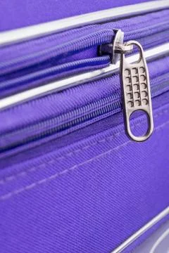 Pull Tab and Chain of a Zipper on a Violet Suitcase Stock-Fotos