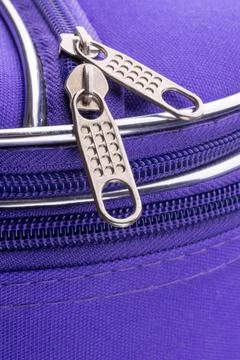 Pull Tab and Chain of a Zipper on a Violet Suitcase Macro of a zipper show... Stock Photos