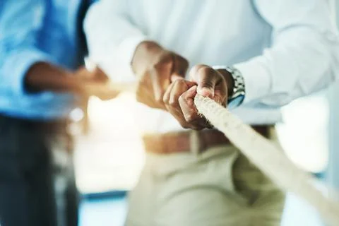 Pull. unrecognisable businesspeople pulling on a rope during tug of war. Stock Photos