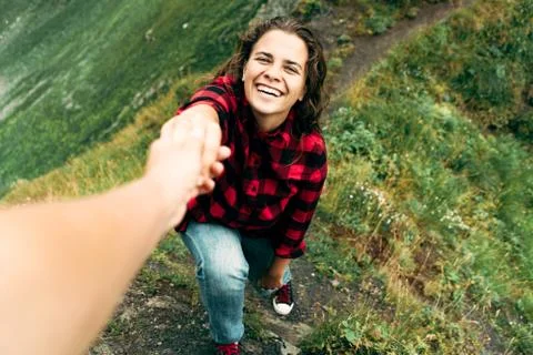 Pull a woman's hand in the mountains Stock-Fotos
