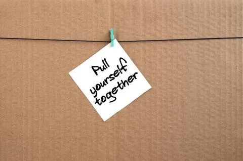 Pull yourself together. Note is written on a white sticker that hangs with a  写真素材