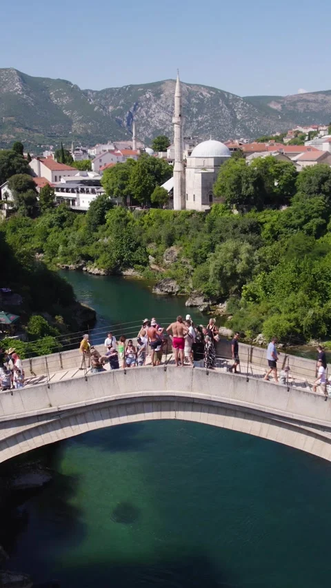 Pullback Aerial of Mostar’s Stari Most Bridge with Golden Midday Glow Stock-Footage 311457691