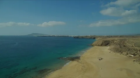Pullback drone shot over beach in Lanzarote Stock Footage 119377204