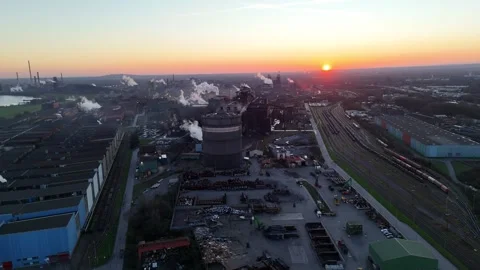 Pullback over riverfront industry toward distant plant Stock Footage 331201770