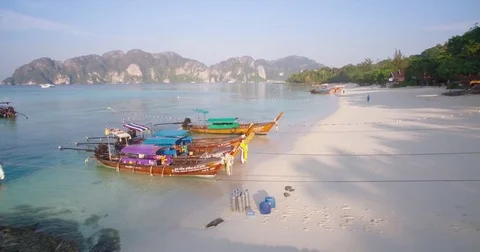 Pullback Reveal Aerial Shot of Long Tail Boats on Tropical Beach, Phi Phi Stock Footage 78834642