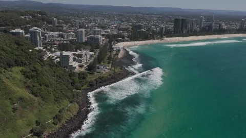 Pullback Reveal Of Burleigh Heads - Lush Green Headland With Rocky Shoreline In Stock Footage 334002931