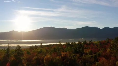 Pullback shot of Mountian valley during sunrise foliage season with colorful Stock Footage 253489311