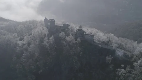Pullback shot old ruined castle on the hill surrounded by white frozen trees, 4K Stock Footage 73232244