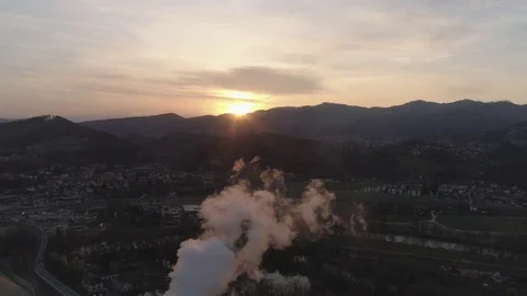 Pullback shot overlooking a steam cloud forming in the beautiful sunset sky, 4K Stock Footage 74272452