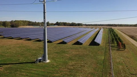 Pullback Shot of a Solar Farm and Powerlines Stock Footage 118488215