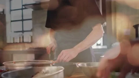 Pullback showing chef chopping with knife arranging bowls for kitchen prep as Stock-Footage 333720214