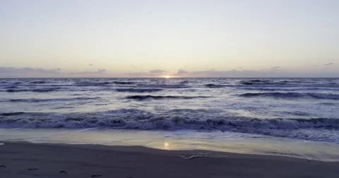 Pullback waves hitting the beach at sunset Stockbeeldmateriaal 232029181