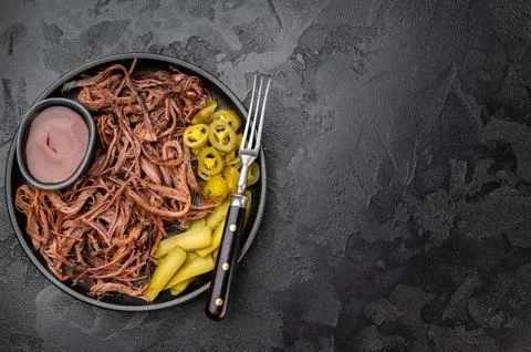 Pulled beef brisket with barbecue sauce, pickles and jalapeno in skillet on.. Stock Photos