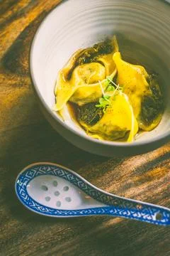 Pulled Duck dumpling with brodo, pickled kale, juniper kombu oil Stock Photos