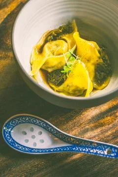 Pulled Duck dumpling with brodo, pickled kale, juniper kombu oil Stock Photos